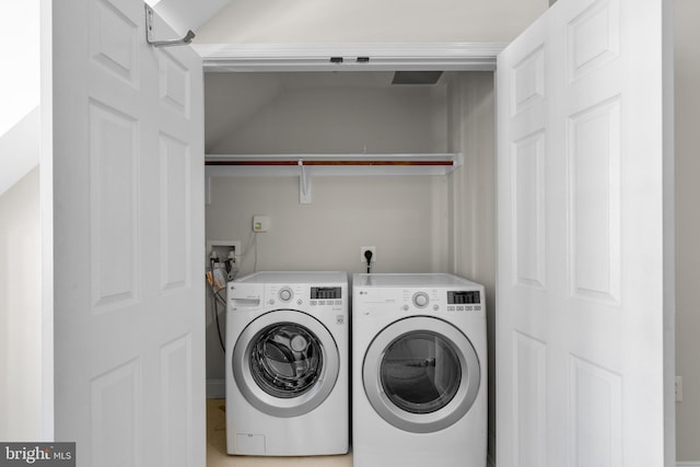 clothes washing area featuring washer and dryer