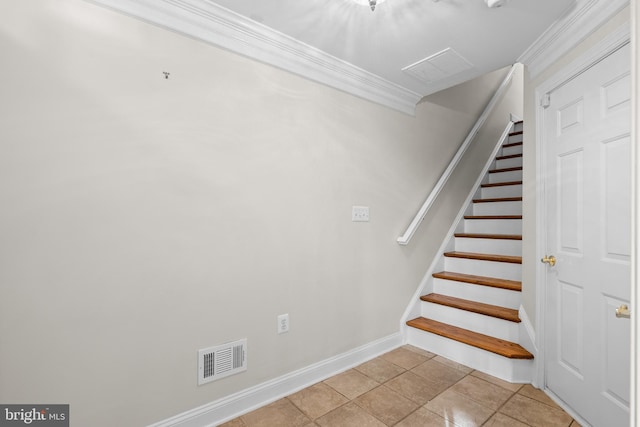 staircase featuring tile patterned floors and crown molding