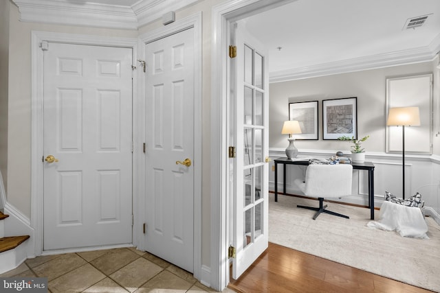 interior space with tile patterned flooring and ornamental molding