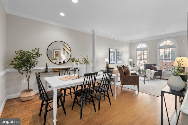 dining room featuring light hardwood / wood-style flooring and ornamental molding