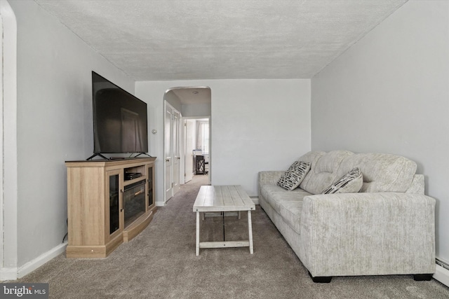 living room with carpet floors, a textured ceiling, and a baseboard heating unit