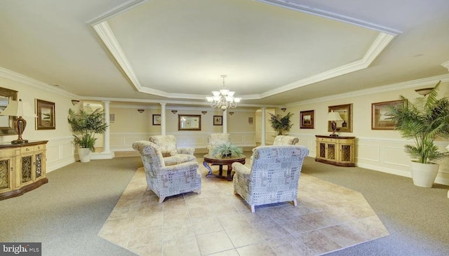 living room with light colored carpet, ornamental molding, a raised ceiling, and ornate columns