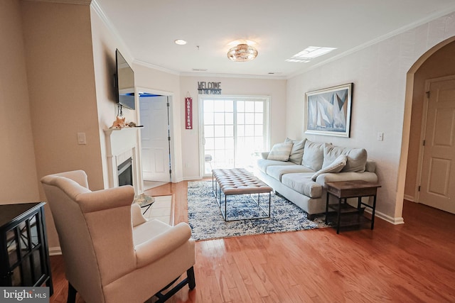 living room with ornamental molding and hardwood / wood-style floors