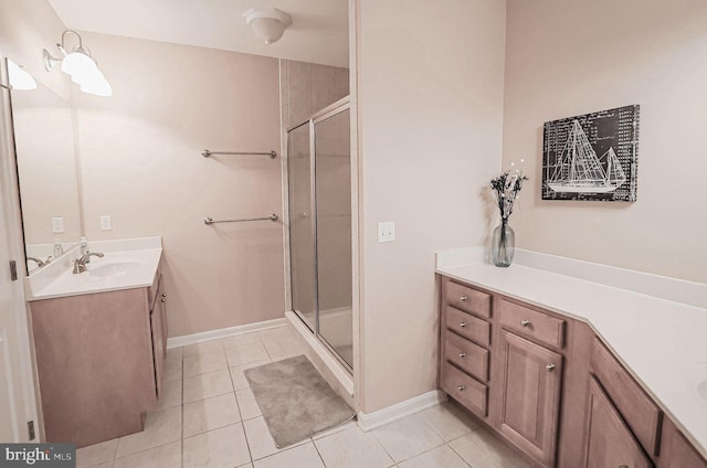 bathroom with an enclosed shower, vanity, and tile patterned flooring