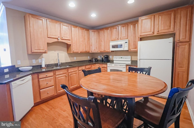 kitchen with sink, crown molding, light brown cabinets, light wood-type flooring, and white appliances