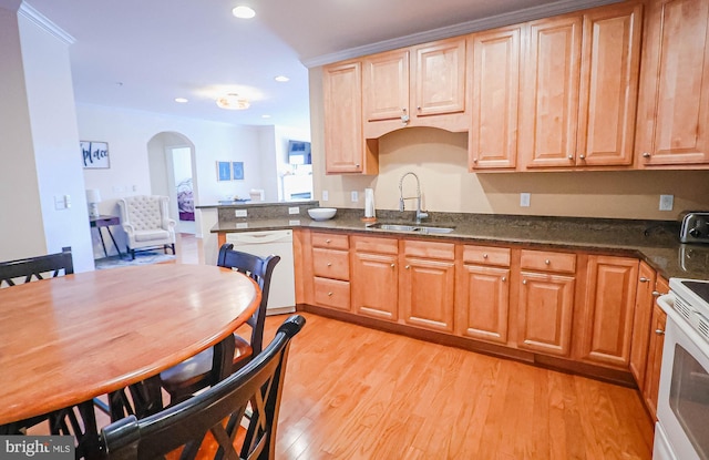 kitchen featuring dark stone countertops, sink, white appliances, and light wood-type flooring