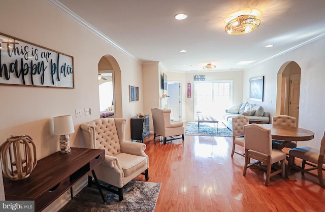 dining area with ornamental molding and hardwood / wood-style floors