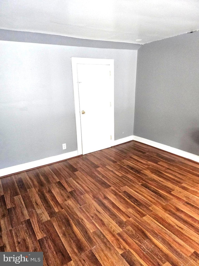 unfurnished room featuring dark hardwood / wood-style flooring