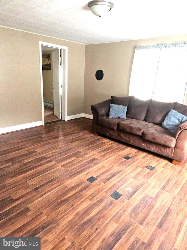 unfurnished living room with hardwood / wood-style flooring and baseboard heating