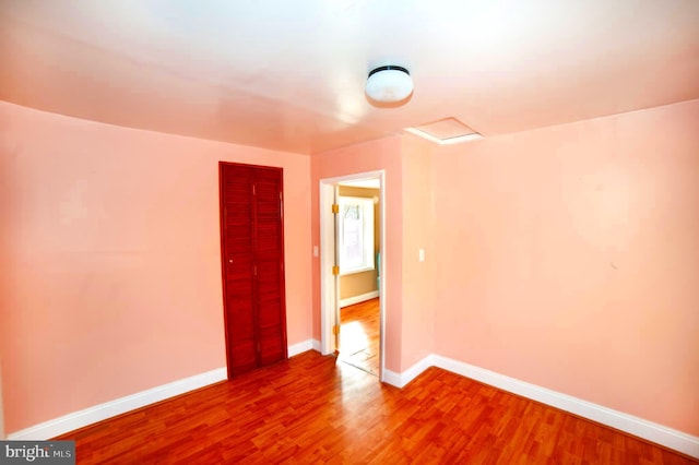 empty room with hardwood / wood-style floors