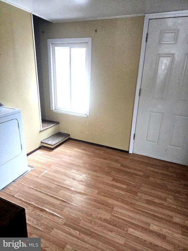 foyer featuring washer / dryer and light hardwood / wood-style flooring