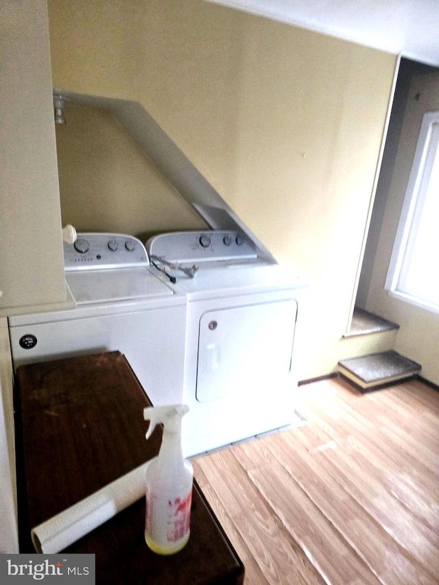 laundry area with hardwood / wood-style flooring and washer and dryer