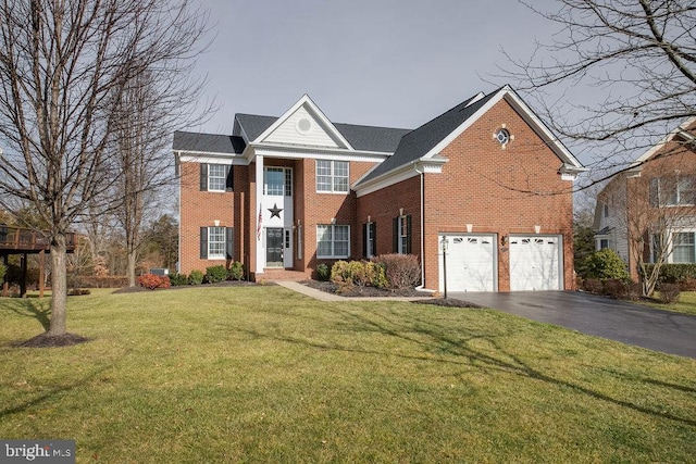 view of property featuring a front yard and a garage