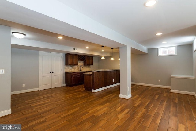 basement with sink and dark wood-type flooring