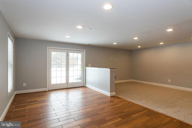 spare room featuring plenty of natural light and dark carpet