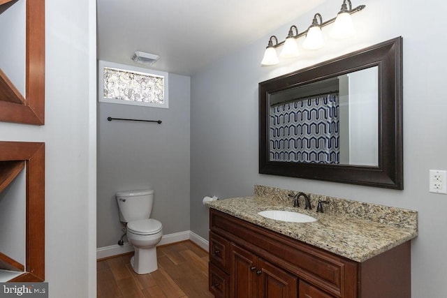 bathroom featuring vanity, toilet, and hardwood / wood-style floors