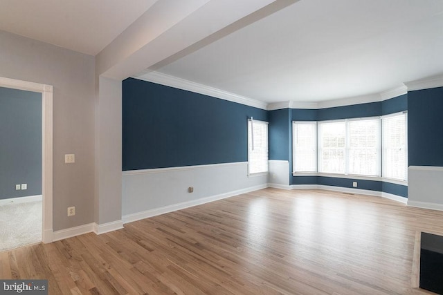 unfurnished room featuring light wood-type flooring and crown molding