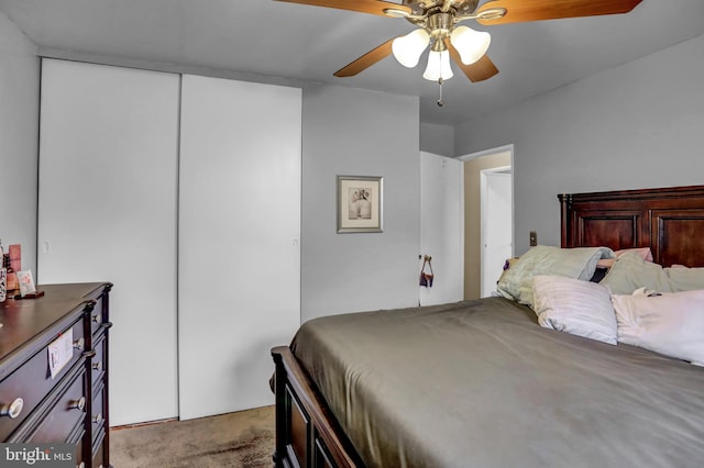 carpeted bedroom featuring a closet and ceiling fan