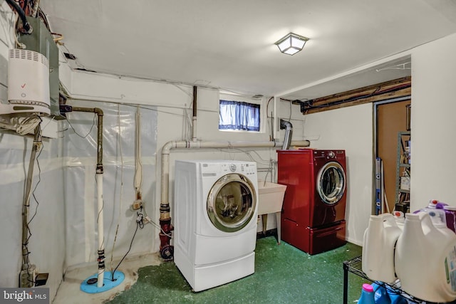 clothes washing area featuring sink and washer and dryer