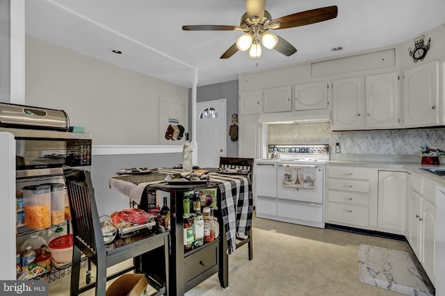 kitchen with decorative backsplash, white cabinets, ceiling fan, and electric stove