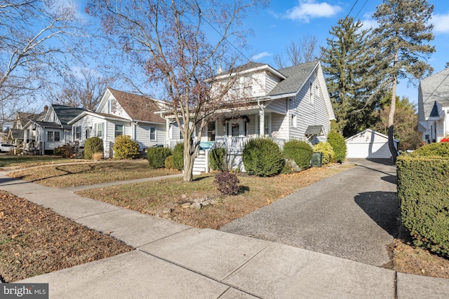 bungalow-style house featuring a garage, an outdoor structure, and covered porch