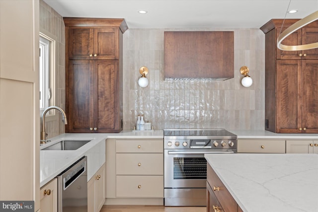 kitchen with light stone counters, sink, appliances with stainless steel finishes, and tasteful backsplash