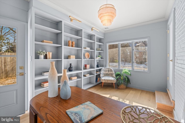 sitting room with built in features and light wood-type flooring