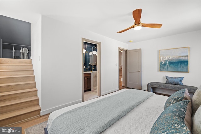 bedroom featuring light wood-type flooring, ceiling fan, and ensuite bathroom