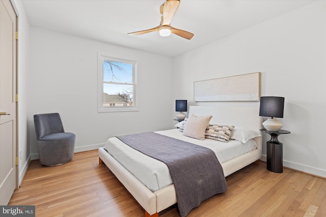 bedroom with light hardwood / wood-style floors and ceiling fan