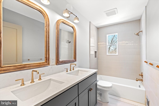 full bathroom with tile patterned floors, toilet, vanity, and tiled shower / bath