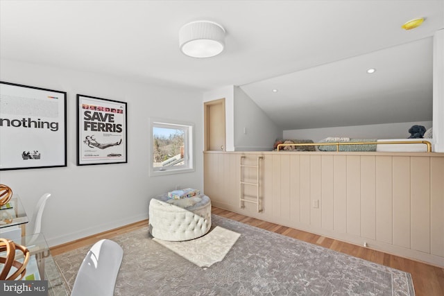 sitting room featuring vaulted ceiling and light hardwood / wood-style flooring