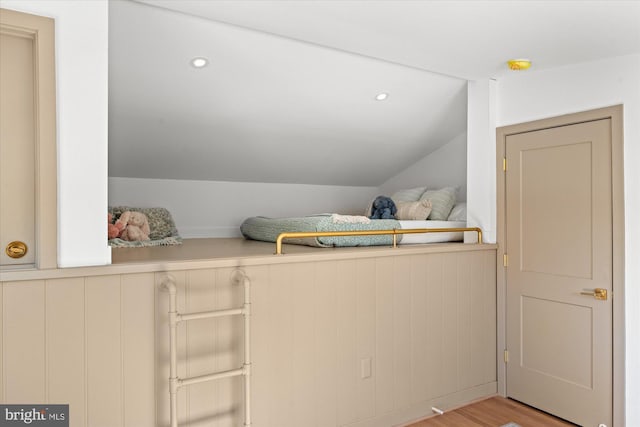 interior space with vaulted ceiling and light hardwood / wood-style floors