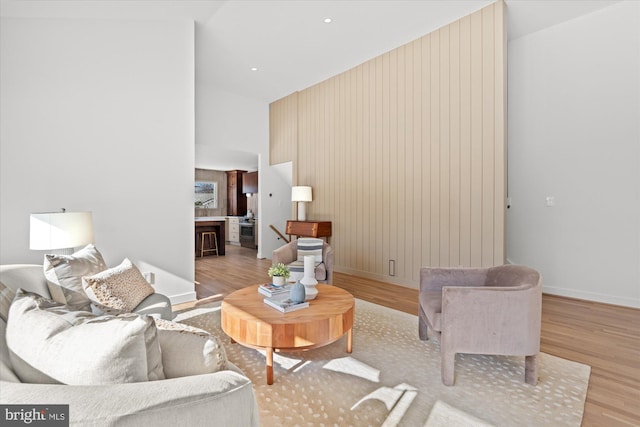 living room featuring vaulted ceiling and light wood-type flooring