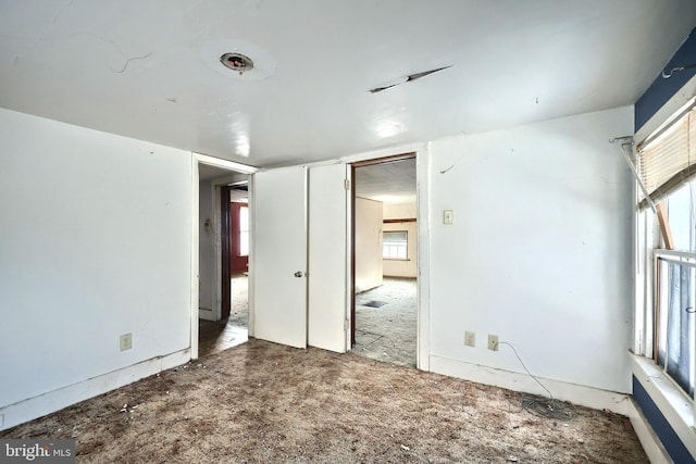 carpeted empty room featuring a healthy amount of sunlight