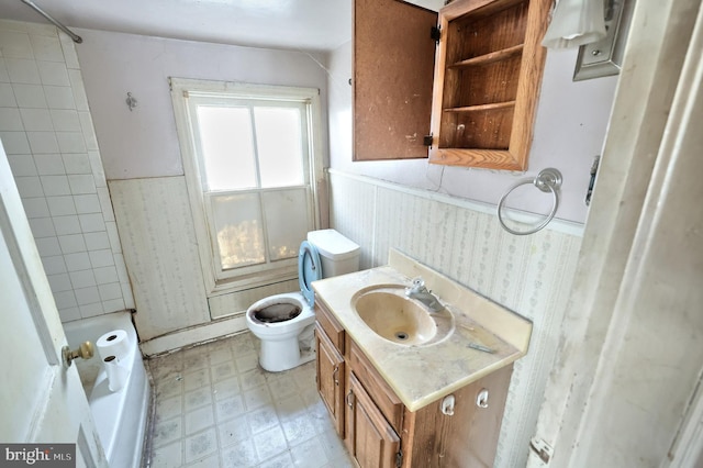 bathroom featuring vanity, toilet, and a tile shower