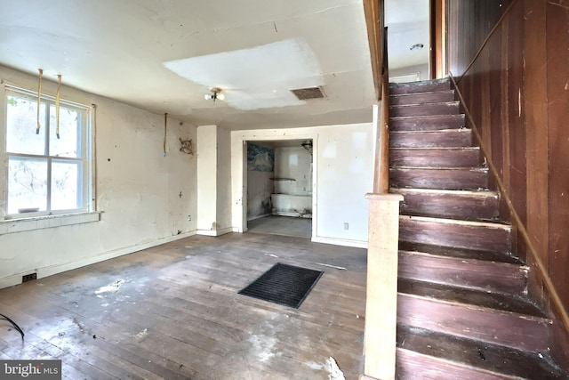 stairs featuring hardwood / wood-style floors