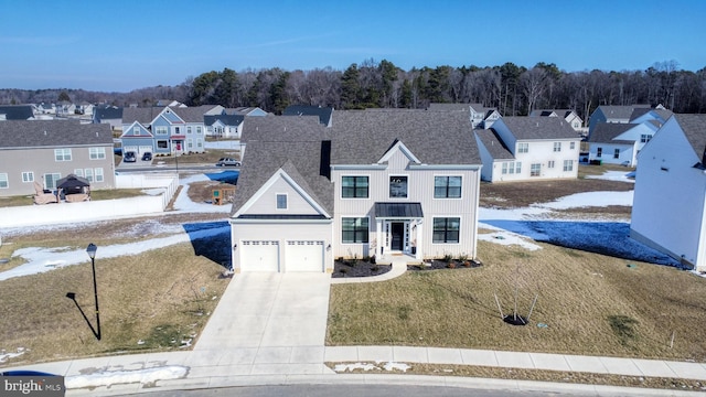 view of front of home with a garage and a front lawn