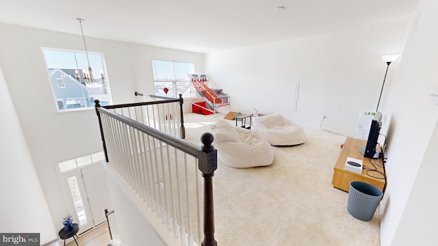 living room featuring carpet flooring and an inviting chandelier