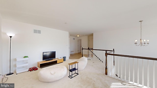 sitting room featuring light colored carpet and a chandelier