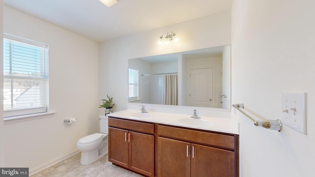 bathroom with vanity, a shower, and toilet