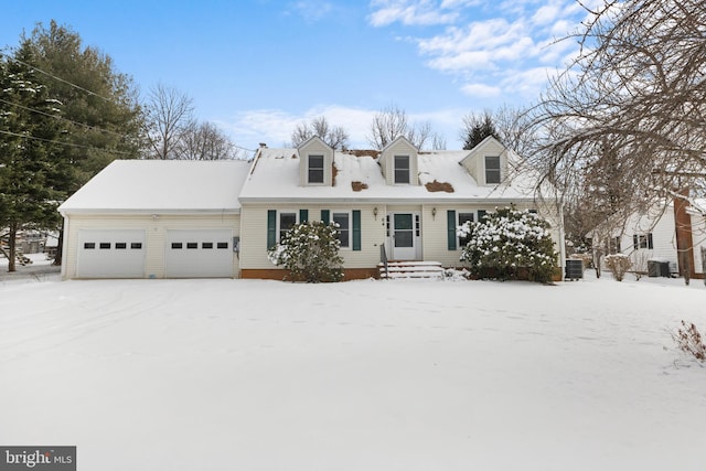 new england style home with a garage and central air condition unit