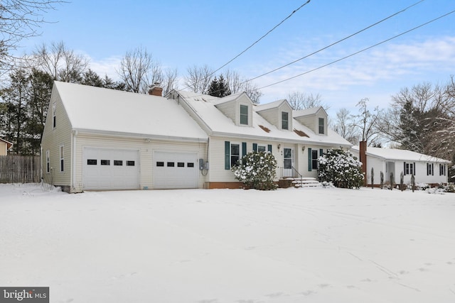 cape cod home with a garage