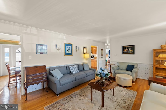 living room featuring ornamental molding and light hardwood / wood-style floors