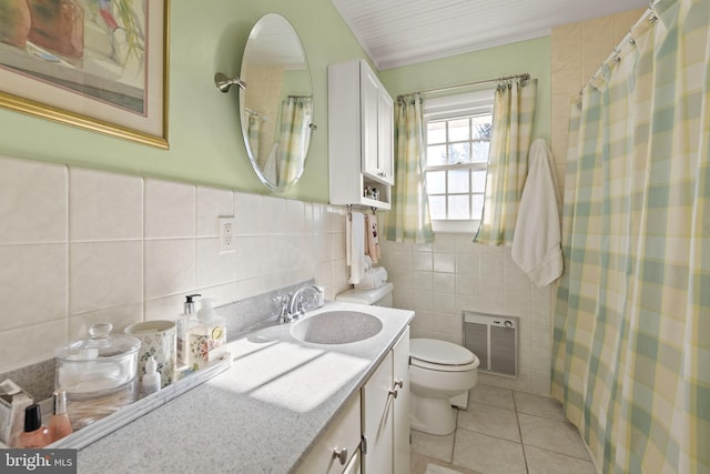 bathroom with tile patterned floors, toilet, tile walls, and vanity