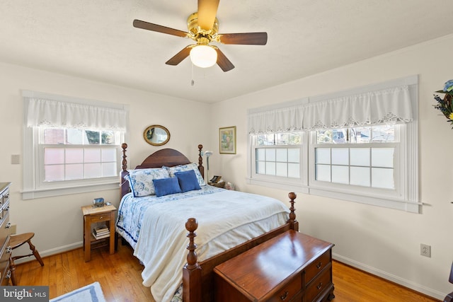 bedroom with ceiling fan and light hardwood / wood-style floors