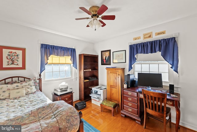 bedroom with ceiling fan and wood-type flooring