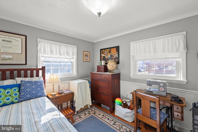 bedroom featuring crown molding and hardwood / wood-style floors