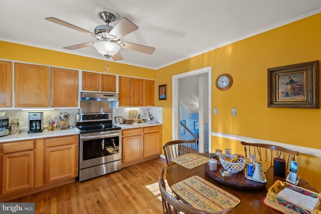 kitchen featuring tasteful backsplash, ornamental molding, stainless steel appliances, and light wood-type flooring