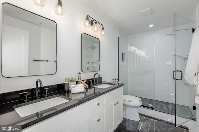 bathroom featuring toilet, an enclosed shower, and vanity