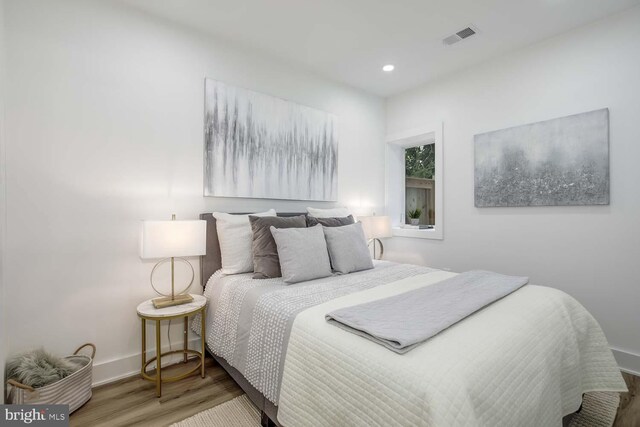 bedroom with wood-type flooring